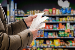 hands holding supermarket bills