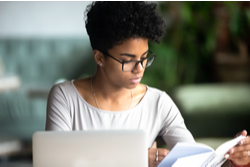 woman in office reading document