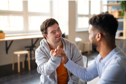 man greets down syndrome customer