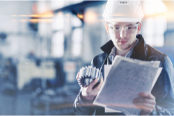 worker checking paperwork in factory