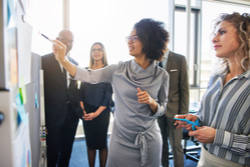 diverse group working together at board