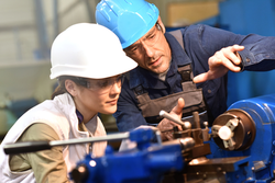 young female factory worker with supervisor