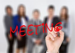 An image of five people and a hand entitled meeting