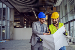 two men looking at building plan