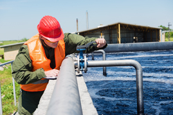 Man inspecting water pipe